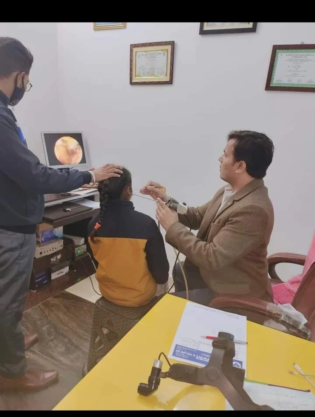 Dr. Manoj Kumar Arya conducting an ear examination with endoscopy monitor